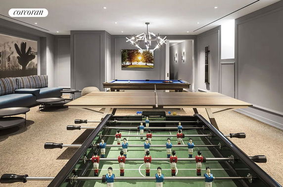 Indoor recreational room with foosball and pool tables.