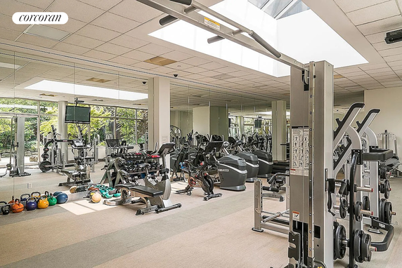 Indoor gym area with exercise equipment and mirrors.