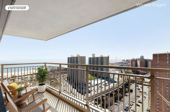 Balcony view overlooking cityscape and ocean.