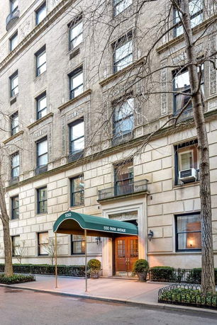 Front view of a multi-story building with a green canopy entrance.