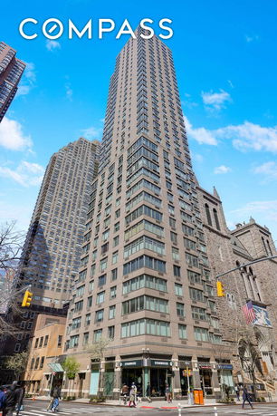 Front view of a tall residential building on a corner lot.