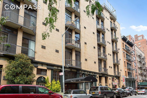 Front view of a multi-story apartment building with balconies.