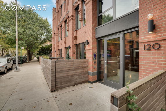 Front view of a brick building with glass door entrance.