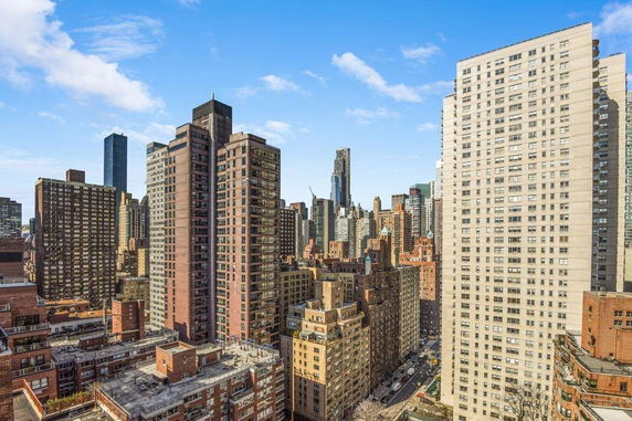 Wide angle view of numerous skyscrapers in a city skyline.