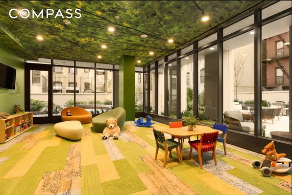 Indoor children's play area with toys, seating, and a colorful ceiling.