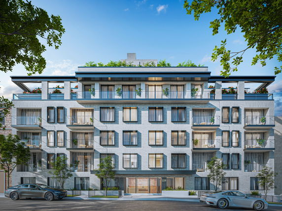 Front view of a multi-story residential building with balconies and rooftop greenery.