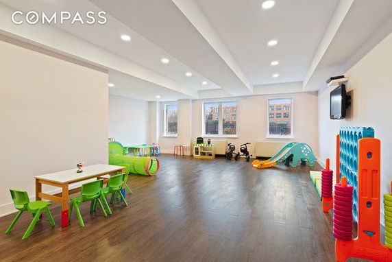 Indoor play area with seating and children's toys.