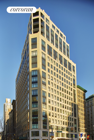 Front view of a tall apartment building with multiple windows.