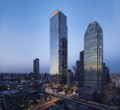 View of tall, glass-covered skyscrapers set against a dusk sky.
