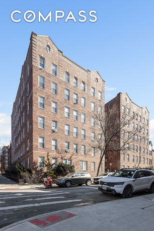 Front view of a multi-story brick apartment building.
