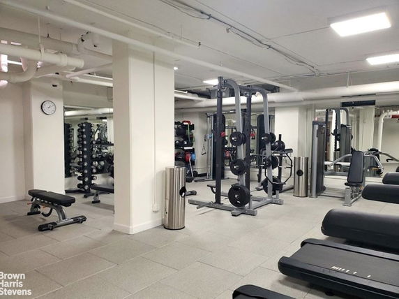 Indoor gym area with fitness equipment and exercise machines.