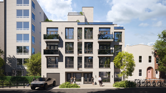 Front view of a multi-story apartment building with balconies.