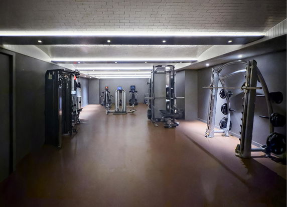 Indoor gym area with various exercise equipment.