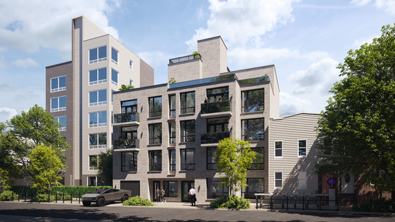 Front view of a modern multi-story building with large windows and balconies.