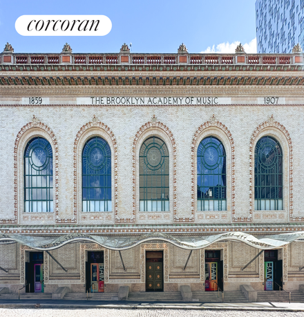 Front view of a historic building with arched windows and ornate detailing.