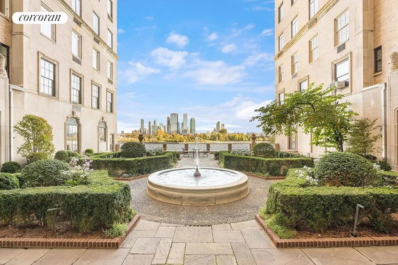 View from a patio between two buildings showing a city skyline in the distance.