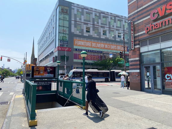 Front view of a multi-story commercial building with a CVS pharmacy and other stores.
