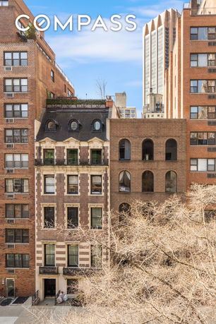 Front view of a multi-story brick building with classic architectural features.