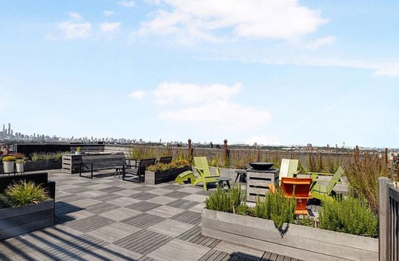 Rooftop area with outdoor seating and planters.