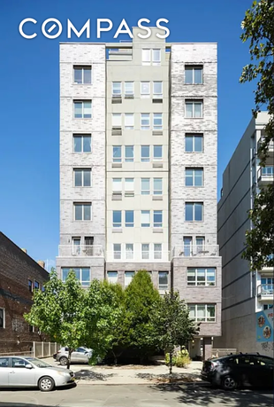 Front view of a multi-story residential building with multiple windows.