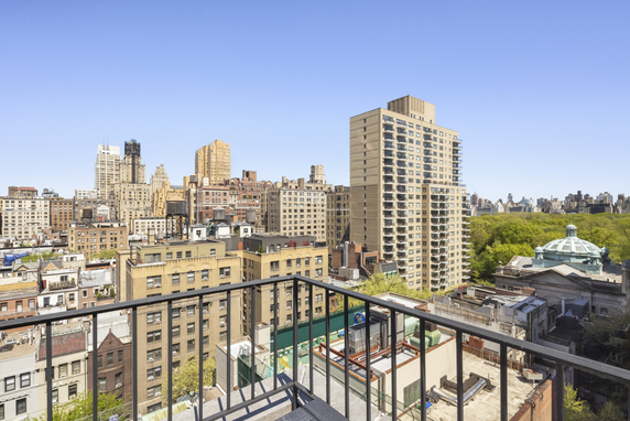 Panoramic view of city buildings from a high vantage point, overlooking a mix of modern and traditional architecture.