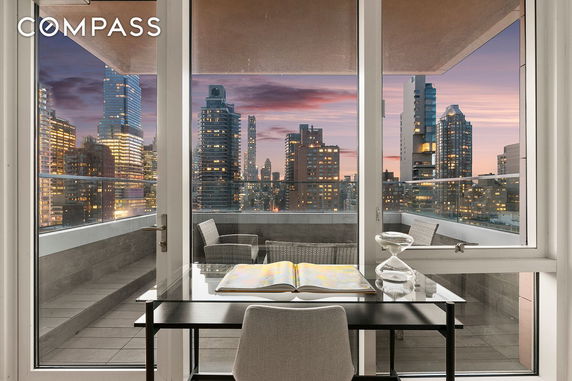 Panoramic view of city skyline from the balcony of a high-rise building.