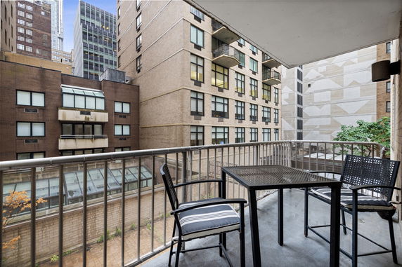 Balcony view from a building showing adjacent high-rise buildings.