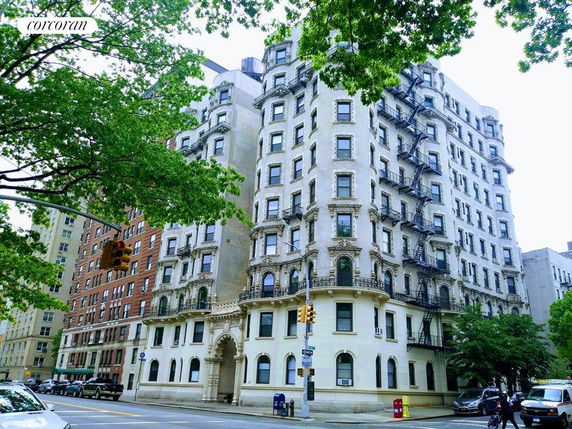 Front view of a multi-story residential building with ornate architectural details and fire escapes.