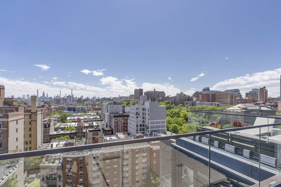 Wide angle view of cityscape with high-rise buildings and greenery.