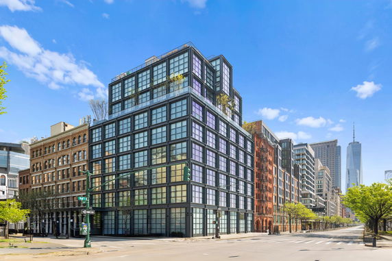 Front view of a modern multi-story building in a city landscape.