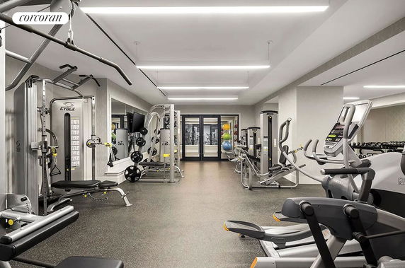Indoor gym area with various exercise equipment.