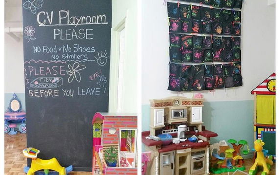 Indoor play area with educational toys and chalkboard.