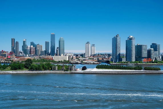 Panoramic view of a city skyline across a body of water.