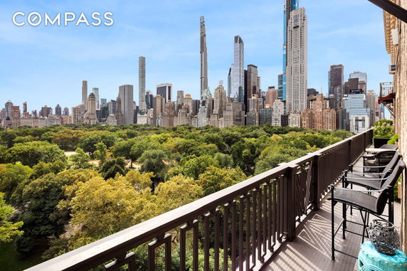 Panoramic view of city skyline and park from a high-rise balcony.