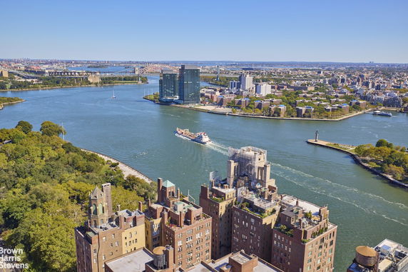Panoramic view of a cityscape with river and buildings.