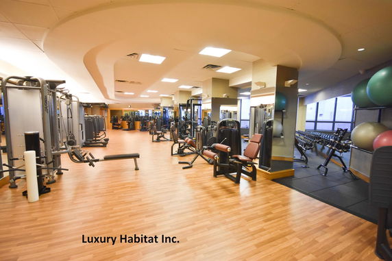 Interior view of a gym area with various exercise equipment.