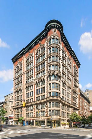 Front view of a multi-story historic building with detailed architectural features.