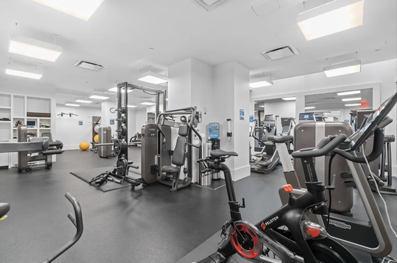 Interior view of a gym with various exercise equipment.