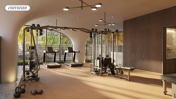 Interior view of a gym room with various workout equipment, including treadmills and weight machines.