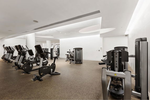 Image of a modern gym with various exercise equipment.
