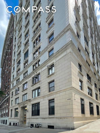 Front view of a multi-story building with decorative facade.