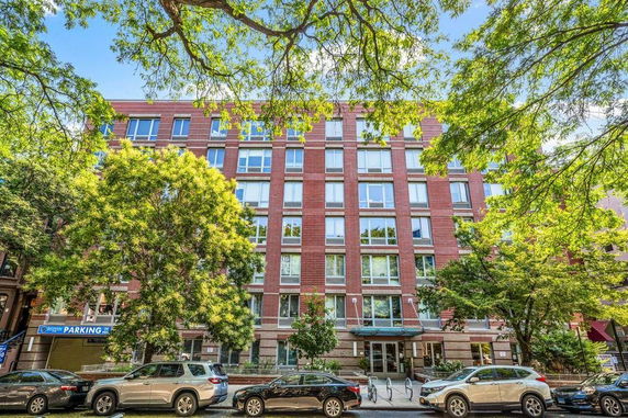 Front view of a multi-story brick apartment building.
