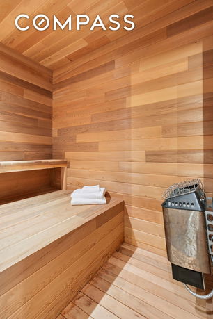 Interior of a wooden sauna room with benches and heater.