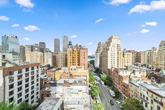 Panoramic view of tall buildings in a cityscape on a clear day.