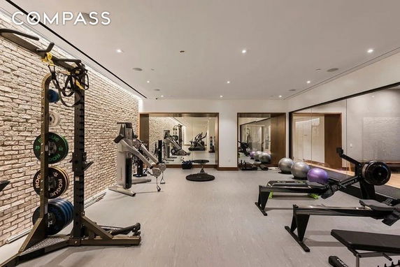 Indoor gym area equipped with exercise machines and fitness gear.