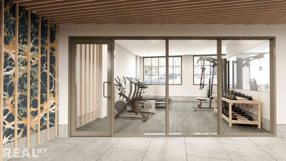 Interior view of a gym with exercise equipment and weights.