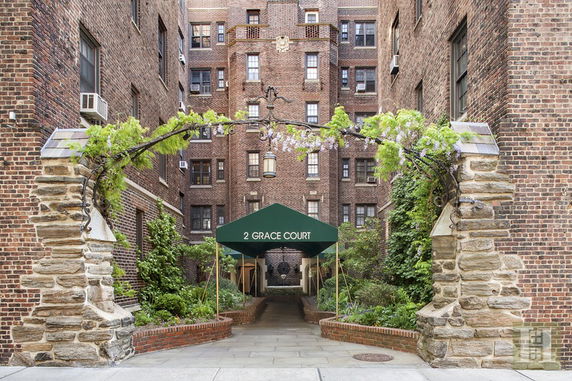 Front view of a multi-story brick building with a green awning entrance.