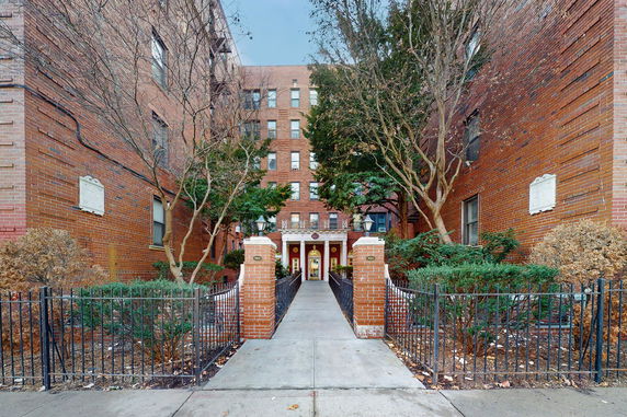 Front view of a multi-story brick building with a central entrance.