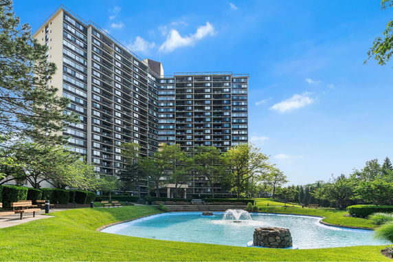 Front view of a multi-story apartment building with numerous balconies.
