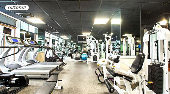 Interior view of a gym with various exercise equipment and machines.